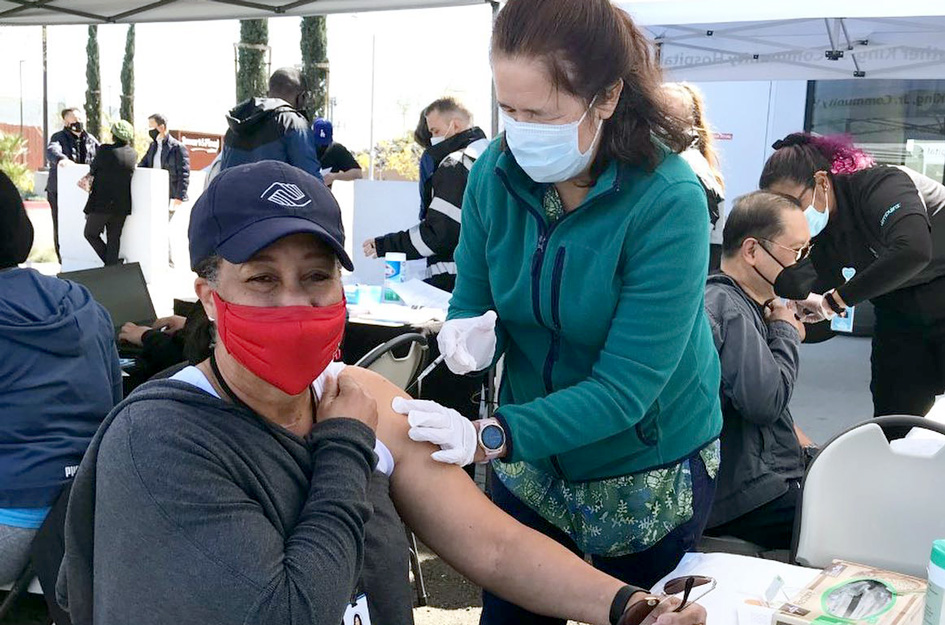 woman being vaccinated at vaccination site